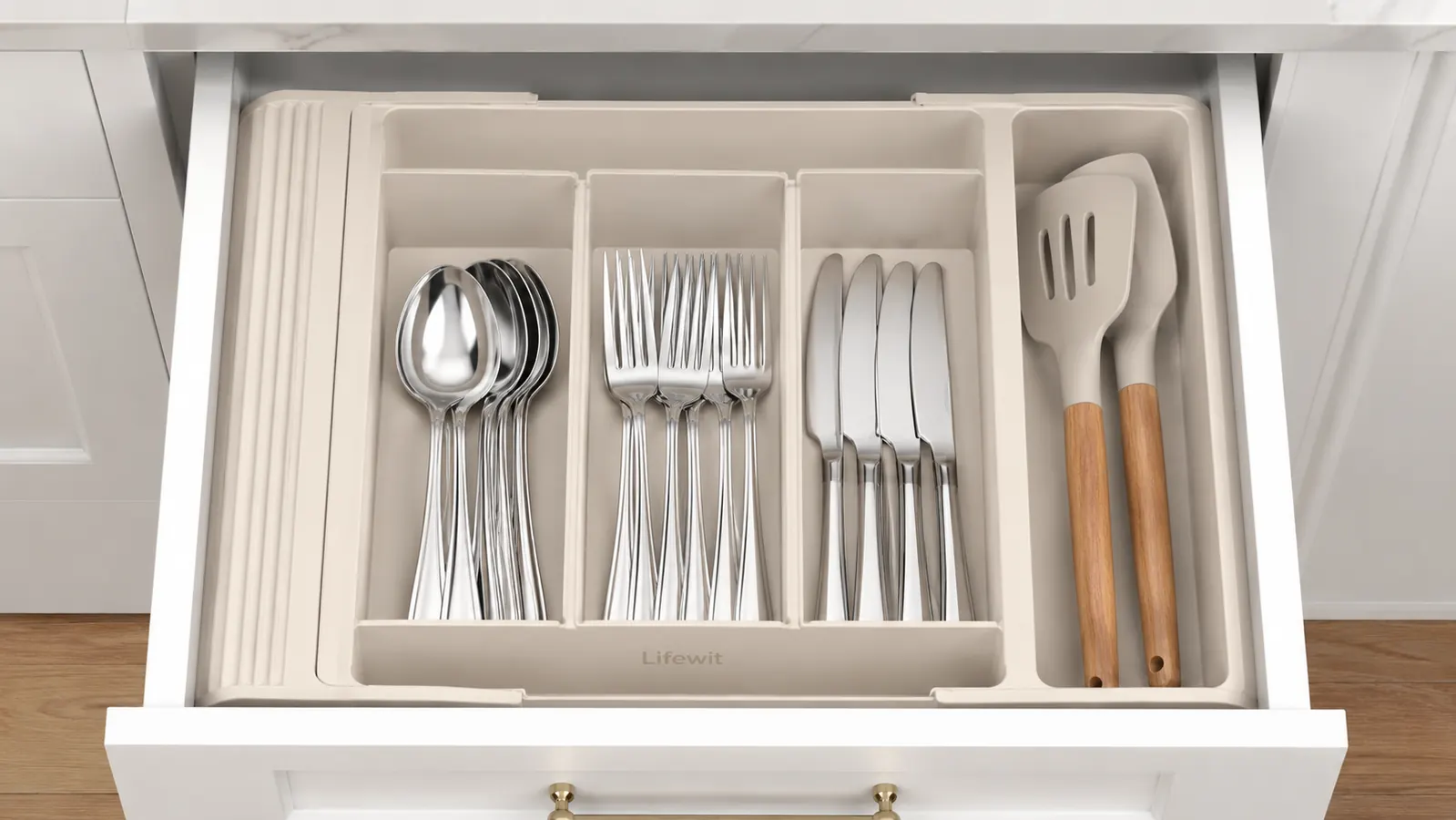 Expandable utensil tray being slid into a kitchen drawer, tray fitting snugly against the drawer sides