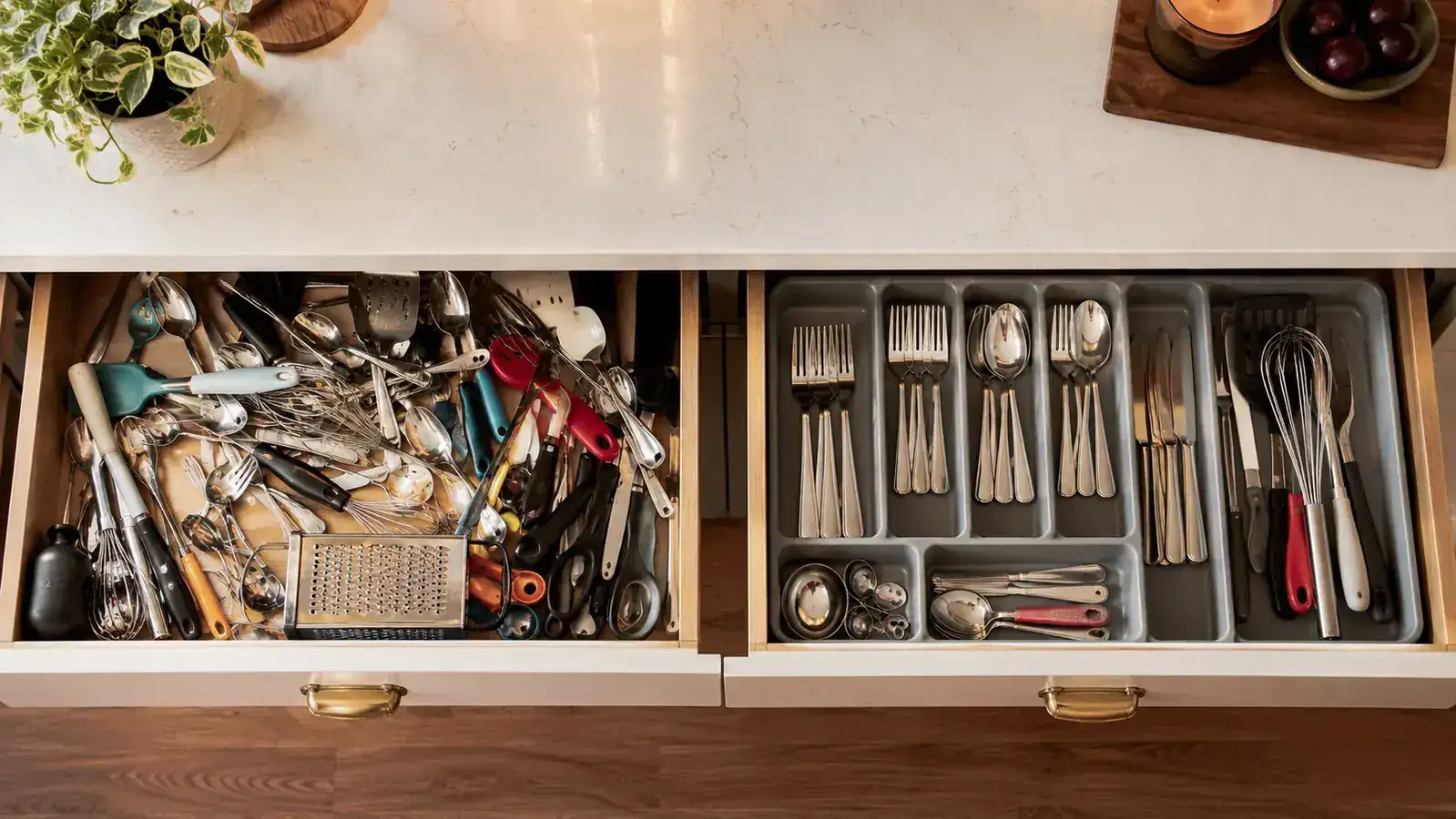 Bamboo spring-loaded drawer dividers installed in a wooden drawer, showing the tension mechanism pressing against drawer walls