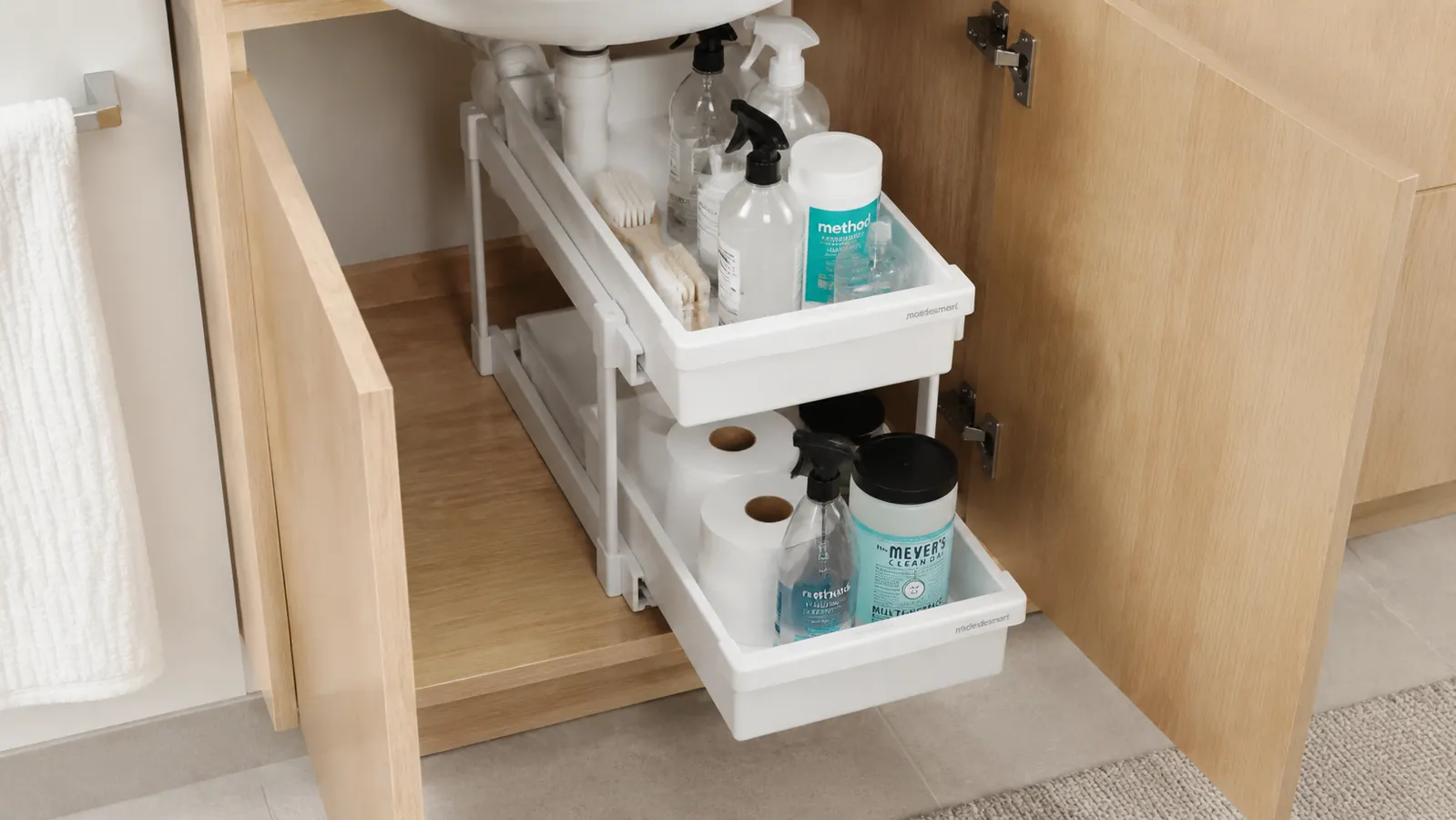 Side profile of the lower sliding drawer extended showing its 2.5-inch interior height next to a standard spray bottle for scale